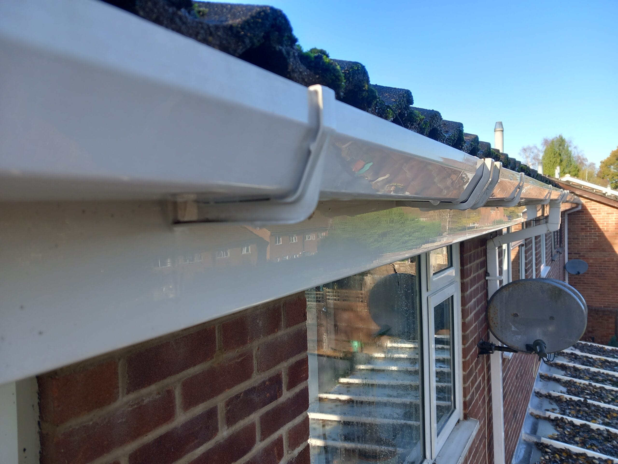 Cleaning dirty fascia and soffits on a Southampton property to restore their original white finish